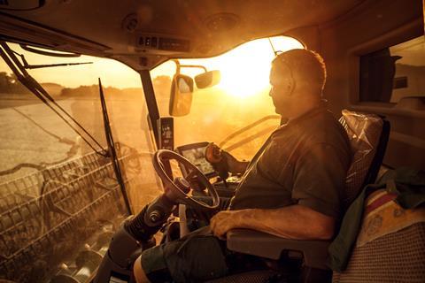 Farmer driving combine harvester
